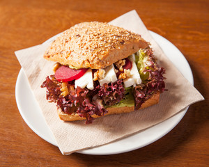 Vegetarian feta sandwich, beautifully arranged and surved on a wooden table