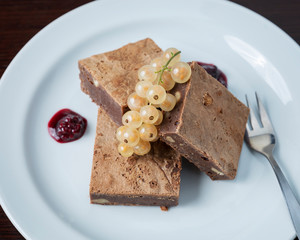 Sweet dessert, chocolate brownie - A slice of cake beautifully arranged with berries on a white plate
