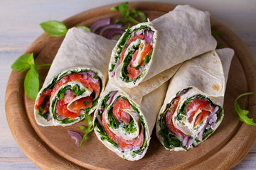 Salmon and cream cheese wraps. Wraps with salmon. Homemade tasty burrito