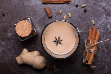 Masala chai tea on the dark background. Hot indian beverage with spices