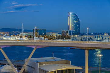 Port Vell with its cruise terminal, bridge Porta d'Europa, Nautic Center and W Barcelona at night