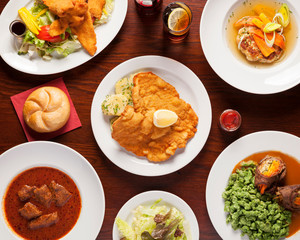 Austrian Food, Schnitzel - Top shot of delicious austrian meals beautifully arangend on a wooden table