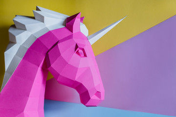 Paper unicorn head on a colored background.