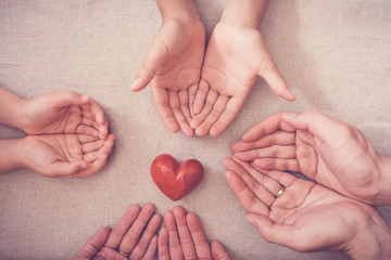 hands and red heart, health insurance, donation and charity concept