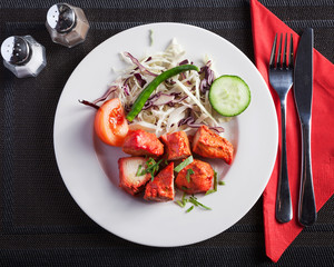 Indian food, Chicken Tikka  - Top down view of delicious oriental dish, beautifully arranged on a wooden table