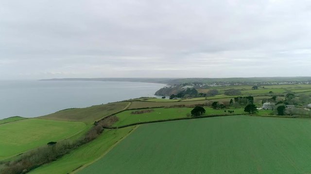 Aerial tracking over fields and coastal landscape in the fertile area of south Devon, near Dartmouth.