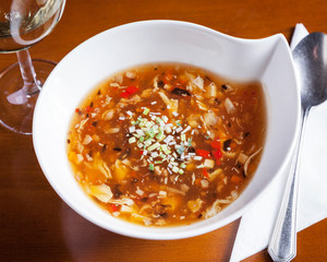 Chinese food, Sweet Sour Soup - Top down view of delicious oriental dish, beautifully arranged on a wooden table