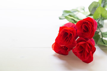 Present gift with red rose flower on wooden table, 14 February of love day with romantic, valentine holiday concept.