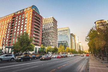 Fototapeta na wymiar Apoquindo Avenue and modern buildings of Las Condes neighborhood at sunset - Santiago, Chile
