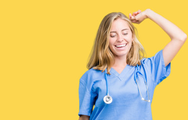Beautiful young doctor woman wearing medical uniform over isolated background Dancing happy and...