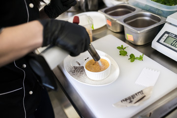 Cream-brulee cooking in a professional kitchen