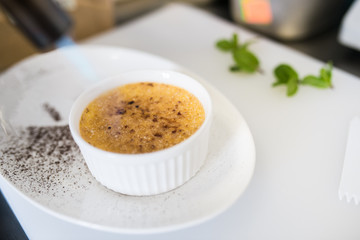 Cream-brulee cooking in a professional kitchen
