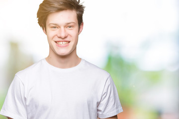 Young handsome man wearing casual white t-shirt over isolated background with a happy and cool smile on face. Lucky person.