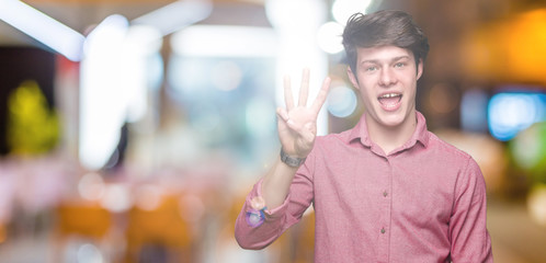 Young handsome business man over isolated background showing and pointing up with fingers number three while smiling confident and happy.