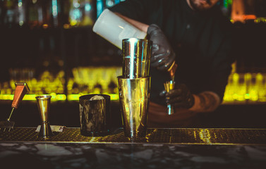 Spill a cocktail. Party. The barman is preparing a cocktail