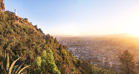 Cerro San Cristobal Hill with virgin statue and aerial view of Santiago during sunset - Santiago,...