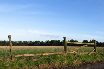 Old wooden fence outside of Northwestern English farmland in Wigan, England.