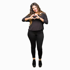 Beautiful young woman with long hair smiling in love showing heart symbol and shape with hands. Romantic concept.