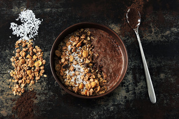 Delicious breakfast bowl with chocolate yogurt and granola. Healthy breakfast.