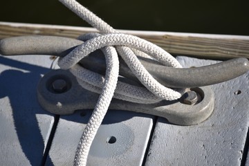 Fototapeta na wymiar Nautical knot tied to a dock cleat