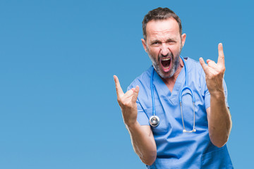 Middle age hoary senior doctor man wearing medical uniform over isolated background shouting with...