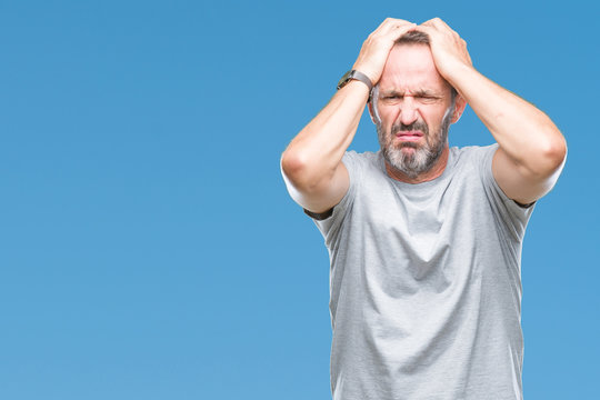 Middle age senior hoary man over isolated background suffering from headache desperate and stressed because pain and migraine. Hands on head.