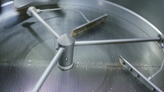 Cooling tray of coffee roastery spinning before a batch of roasted coffee beans