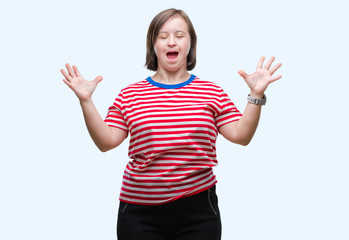 Young adult woman with down syndrome over isolated background crazy and mad shouting and yelling with aggressive expression and arms raised. Frustration concept.