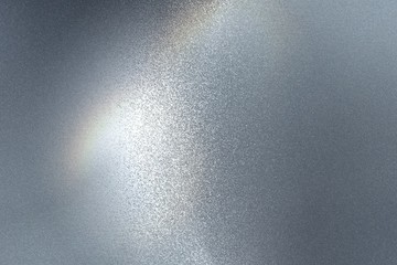 Light shining on rough dark gray steel floor texture, abstract background