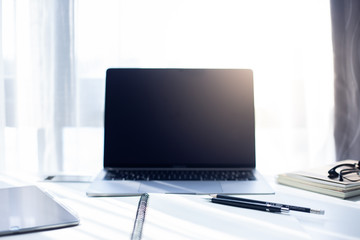 Desk Workplace with laptop  on white table ,Tools used for design ,notebook and tablet