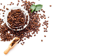 Brown roasted coffee beans scattered on white background top view mockup