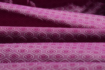 Rippled purple patterned ethnic fabric background