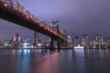 Fototapeta na wymiar View on Queensboro bridge and Midtown Manhattan from east river at night with long exposure