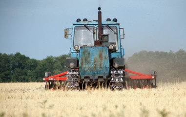 Fototapeta premium Tractor preparing land for sowing