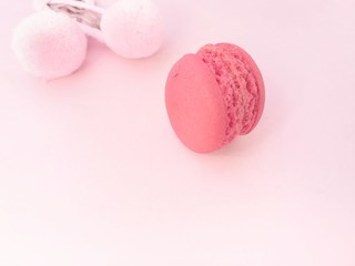 Delicious macaron and pink pom hair clip decorate on pink paper background, beautiful wallpaper, macaroon dessert are sweetie