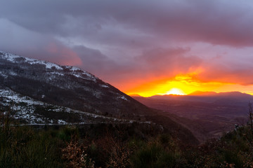 Mountain Landscape at Sunset on Cloudy Sky Background