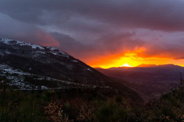 Mountain Landscape at Sunset on Cloudy Sky Background