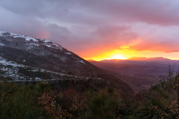 Fototapeta na wymiar Mountain Landscape at Sunset on Cloudy Sky Background