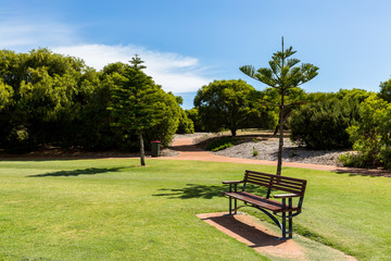 Empty park bench in local suburban park
