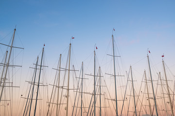 Yacht masts at twilight sky background