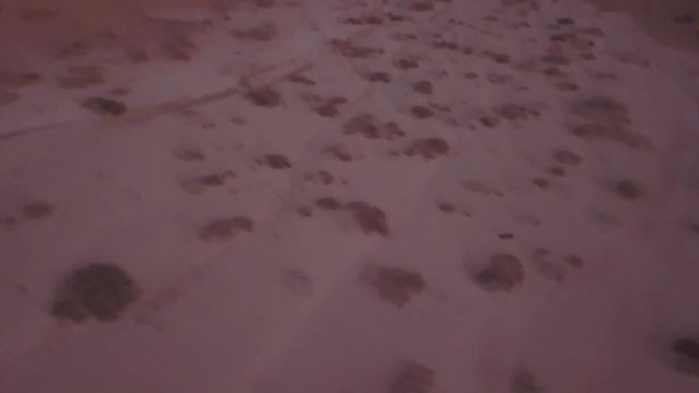 Israel Aerial Drone Of Middle Eastern Camel Owners In Desert Convoy Tourism. Flying View Edom Mountains Arava Rocky Desert with Sand sandy desert and clouds. kibbutz in southern Israel