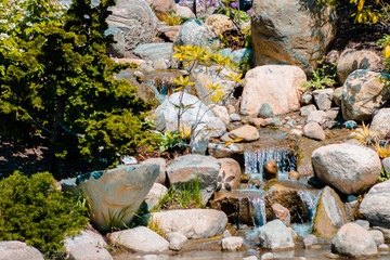 Small waterfall flowing into a pond at the Japanese gardens in Grand Rapids Michigan