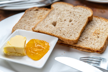 Fototapeta na wymiar Toast with Butter and Apple Jam
