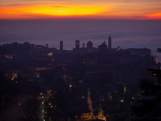 Bergamo, one of the most beautiful city in Italy. Lombardy. Amazing landscape of the fog rises from the plains and covers the old town at sunrise