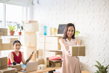 Asian owner woman holding box in home office,Online marketing packing delivery box