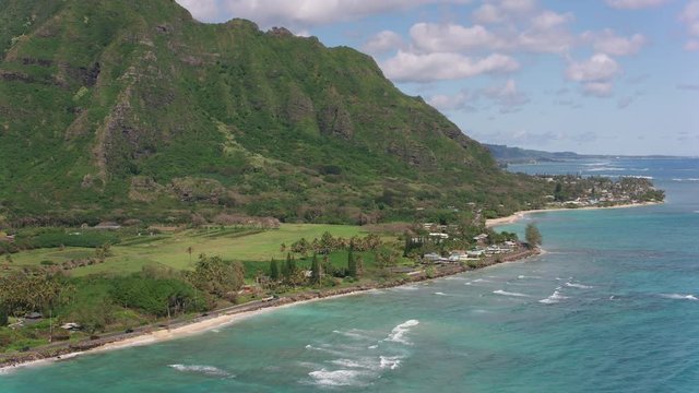 Oahu, Hawaii circa-2018.  Aerial view of beautiful coast line at Kaaawa Valley.  Shot with Cineflex and RED Epic-W Helium. 