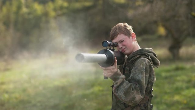 Boy shooting a potato gun in super slow motion