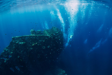 Obraz na płótnie Canvas Free diver man dive at shipwreck and bubbles, underwater