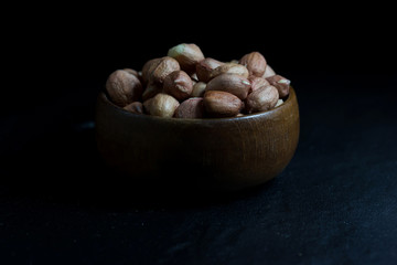 Peanut on Cup made of wood and spoon 
