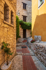Fototapeta na wymiar A charming stone building with flowers and plants in Eze, France